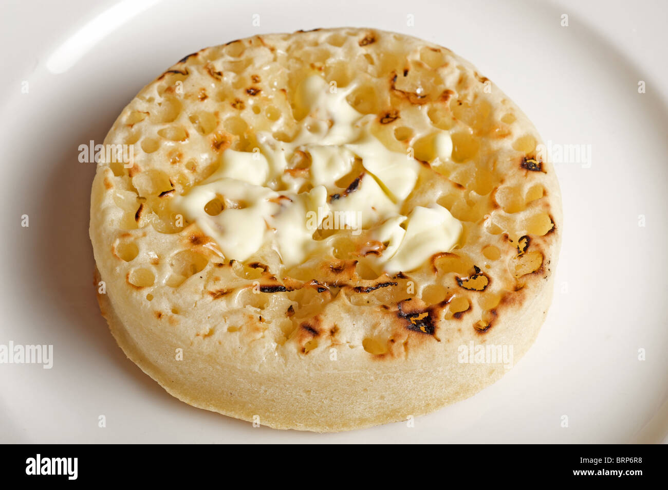 Toasted buttered crumpet Stock Photo