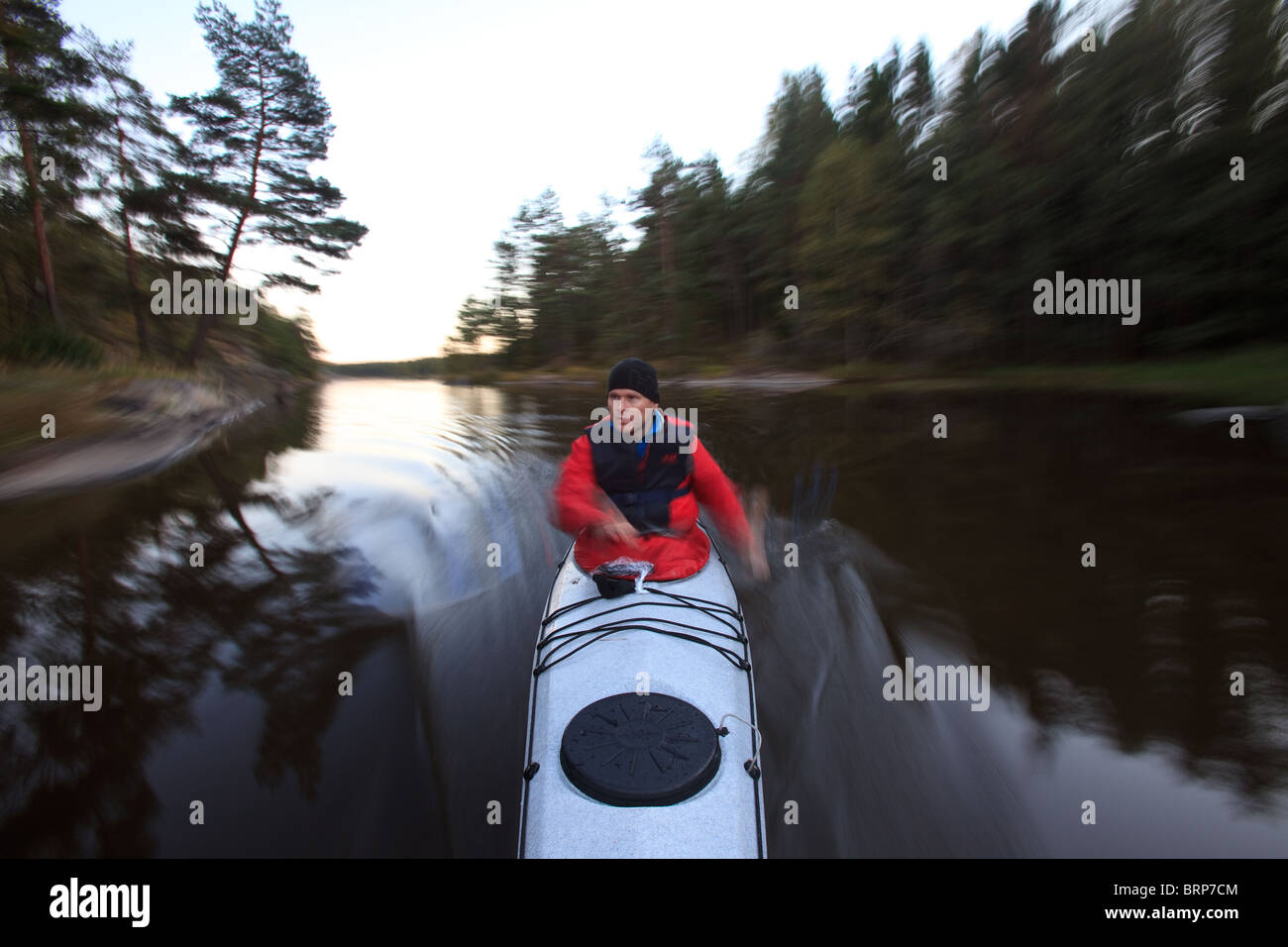 Outdoor photographer Øyvind Martinsen in his kayak in the lake Vansjø, Østfold, Norway. Vansjø is a part of the water system called Morsavassdraget. Stock Photo