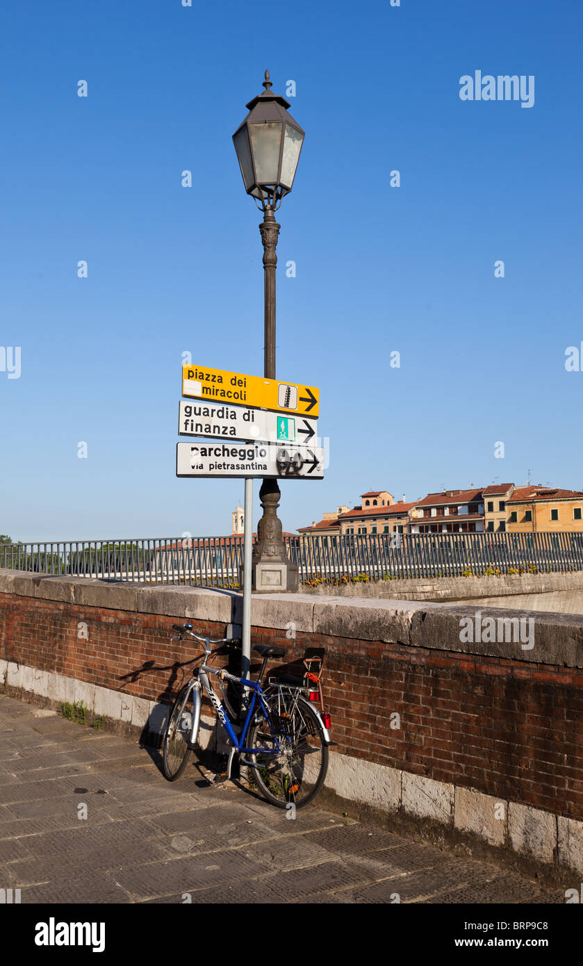 Bicycle parked by the side of the River Arno, Pisa, Italy Stock Photo