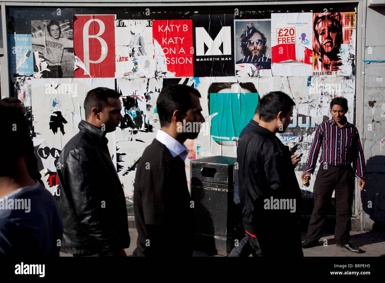 People from various ethnic, predominantly Muslim backgrounds around the market on Whitechapel High Street in East London. Stock Photo