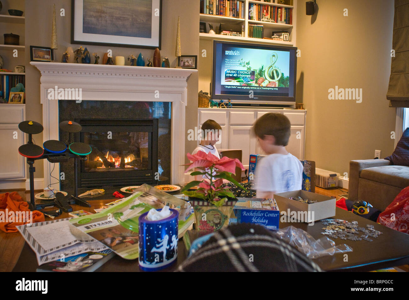 Two young brothers by fireplace with Christmas presents Stock Photo Alamy