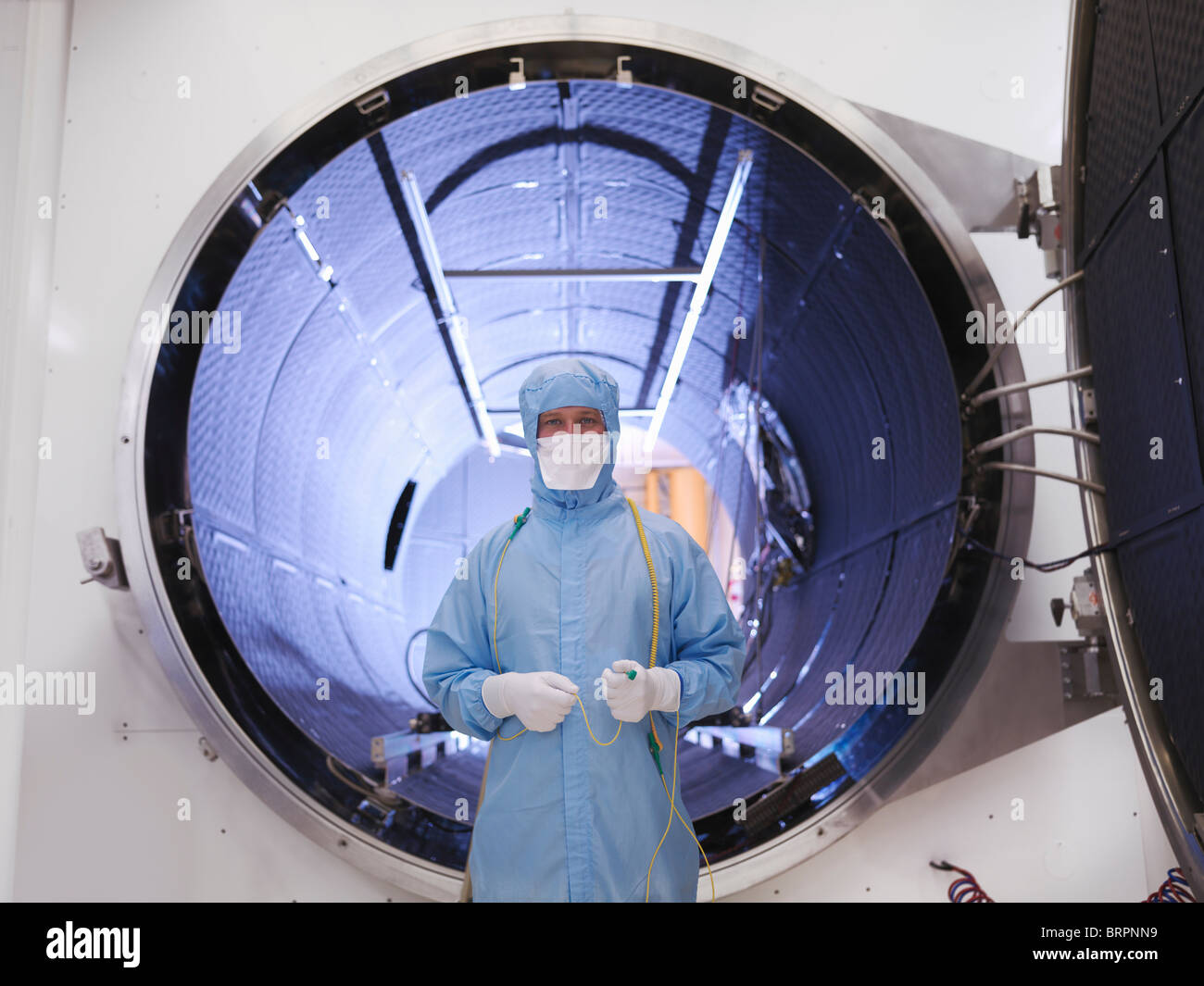 Worker with satellite testing chamber Stock Photo