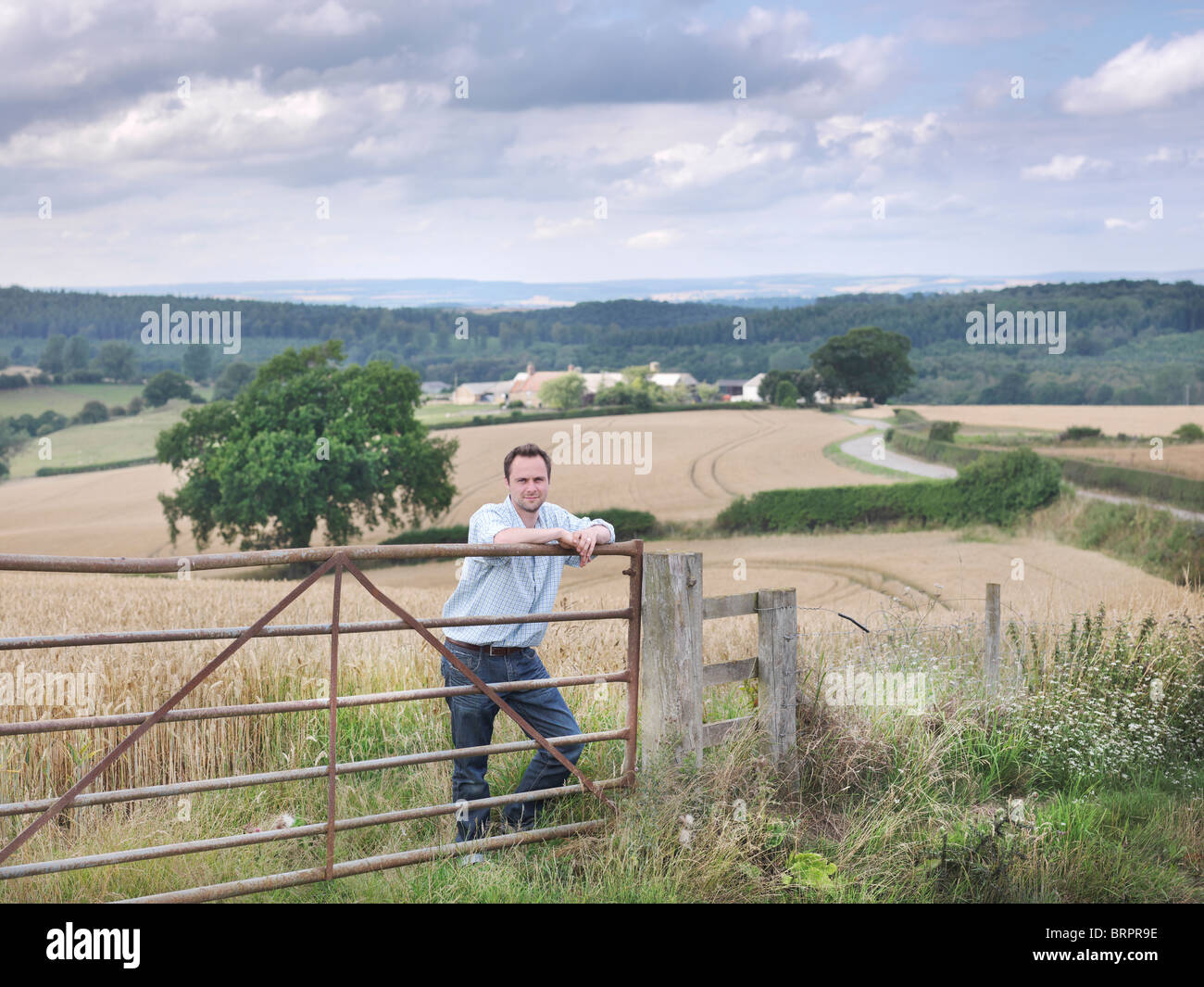 Farmer with crops and farm Stock Photo
