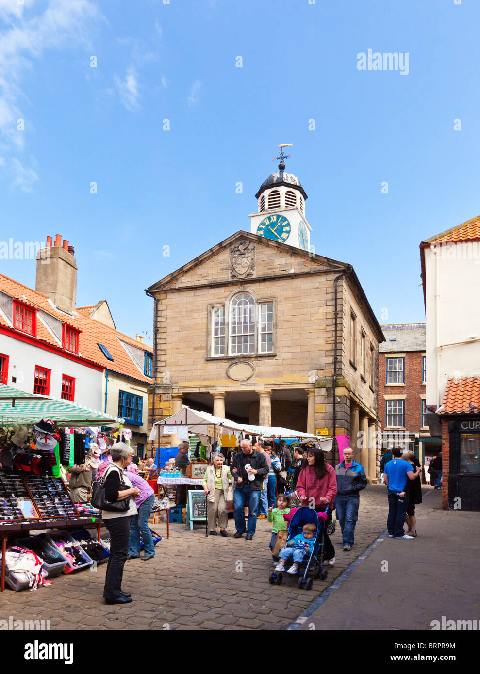 Street market stalls in the old town square Whitby, North Yorkshire, England, UK Stock Photo