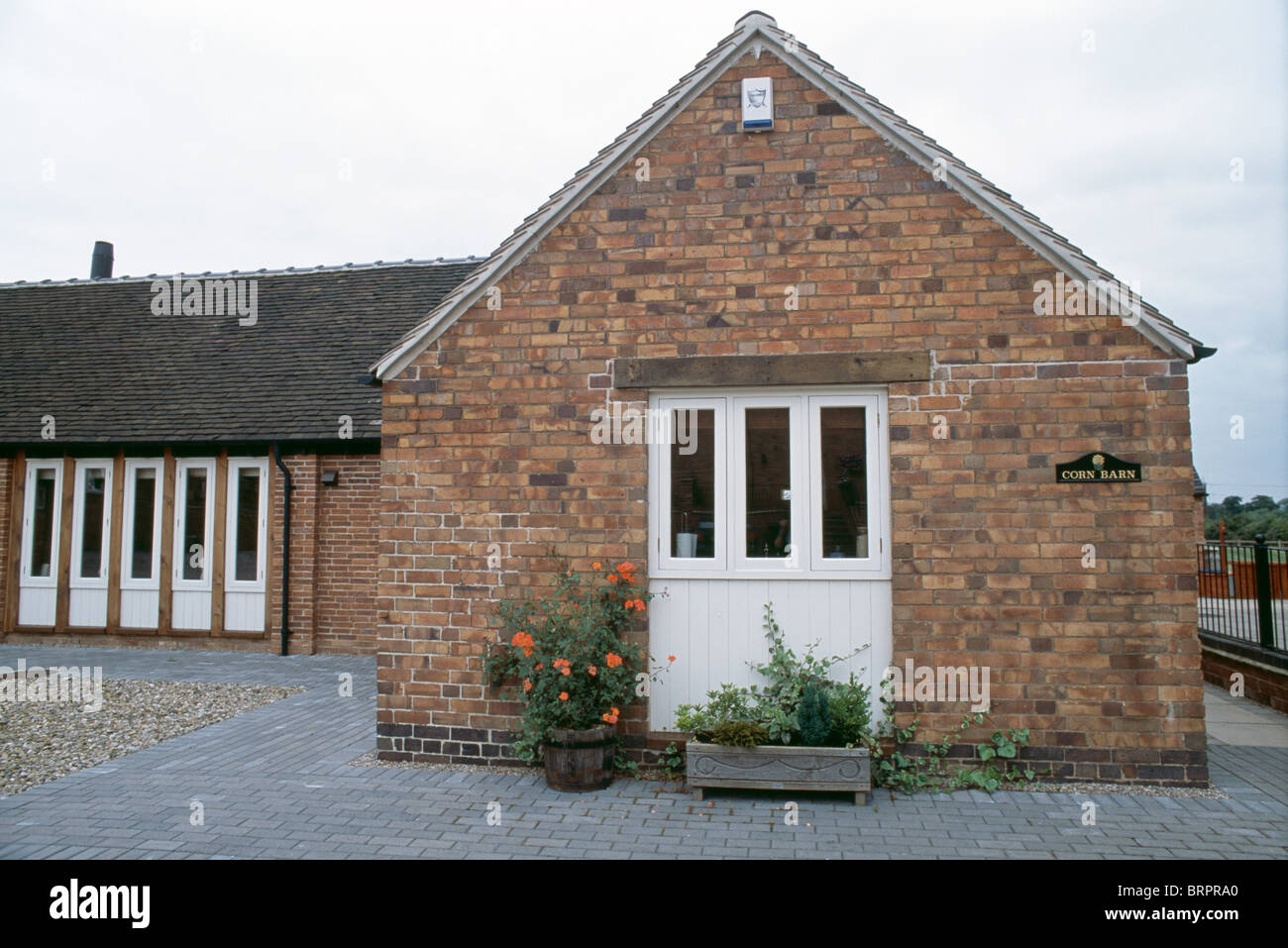 Single Story Barn Conversion With White Painted Windows Stock