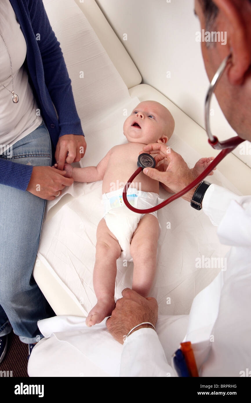 Doctor's surgery, paediatrician. Mother and baby. Medical examination of a 4 month old newborn. Stock Photo
