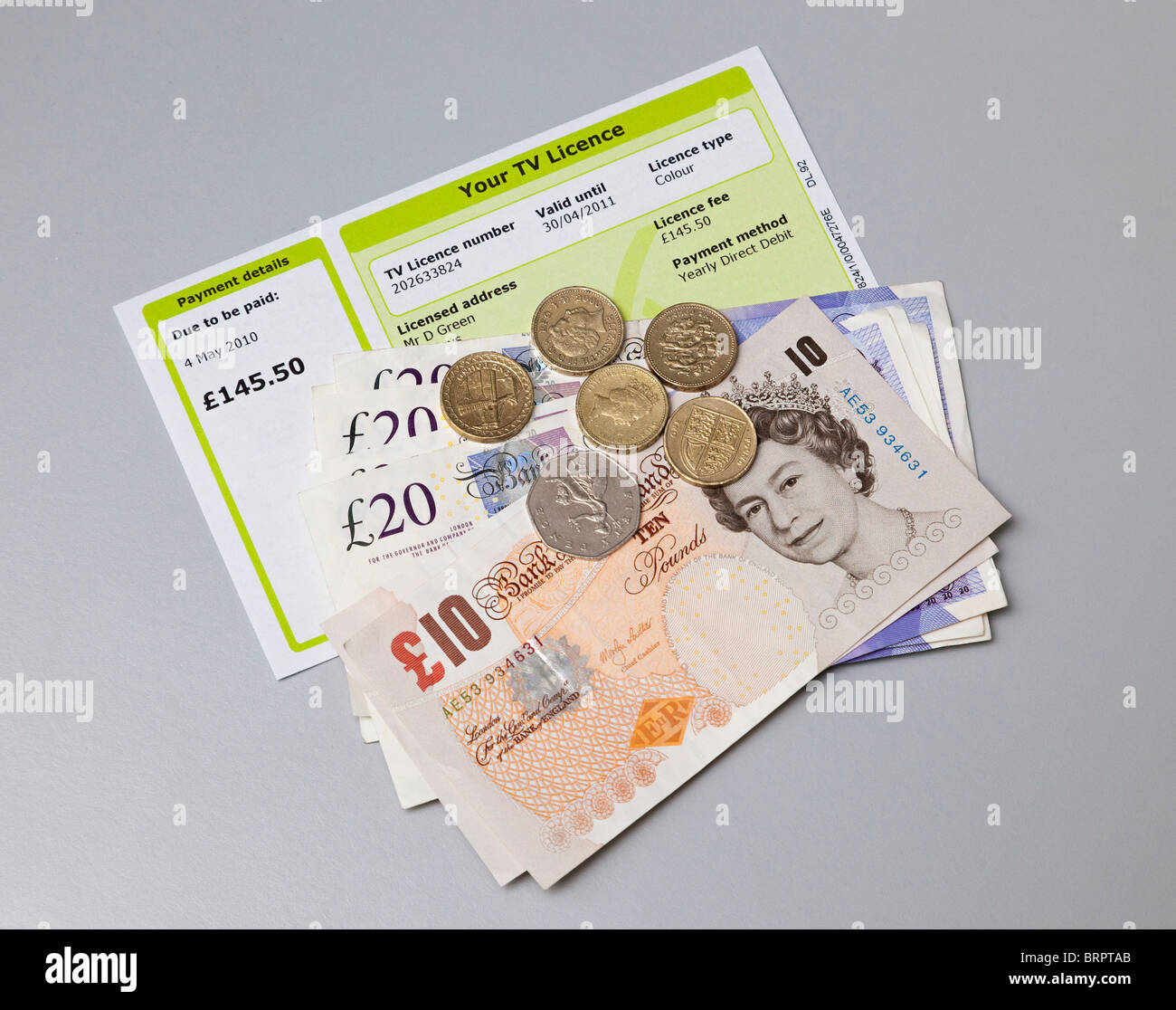 TV licence with cash to pay for it Stock Photo