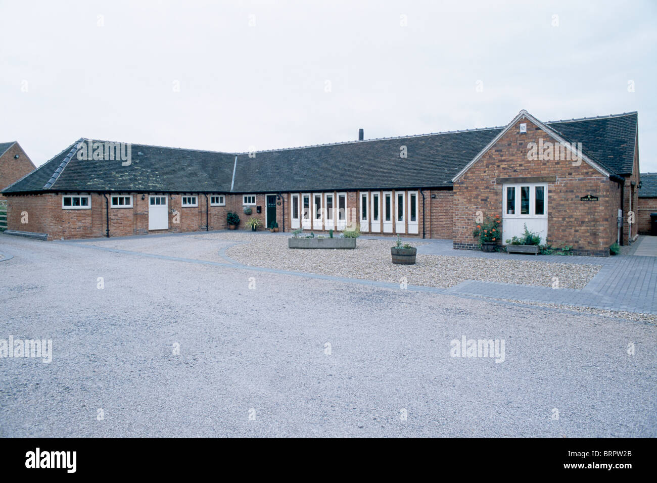 Large Paved Area In Front Of Single Story Barn Conversion Stock