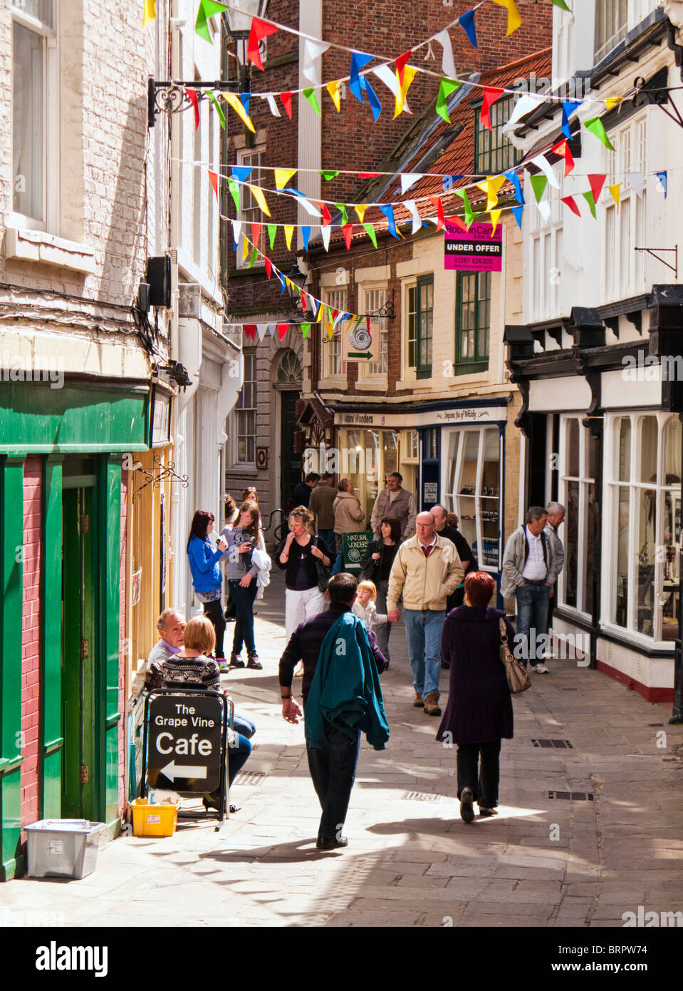 Whitby, Yorkshire, UK - Shoppers and tourists in the pretty old streets of the North Yorkshire town of Whitby, UK Stock Photo