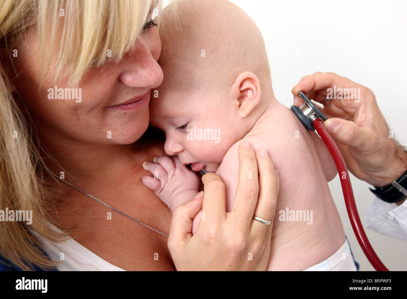 Doctor's surgery, paediatrician. Mother and baby. Medical examination of a 4 month old newborn. Stock Photo