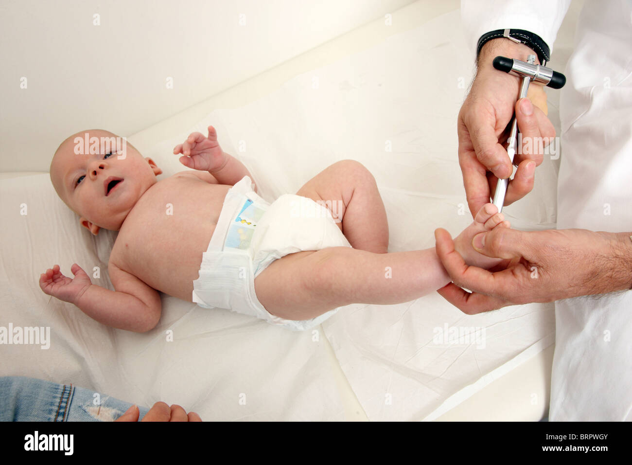 Doctor's surgery, paediatrician. Mother and baby. Medical examination of a 4 month old newborn. Food reflex test. Stock Photo