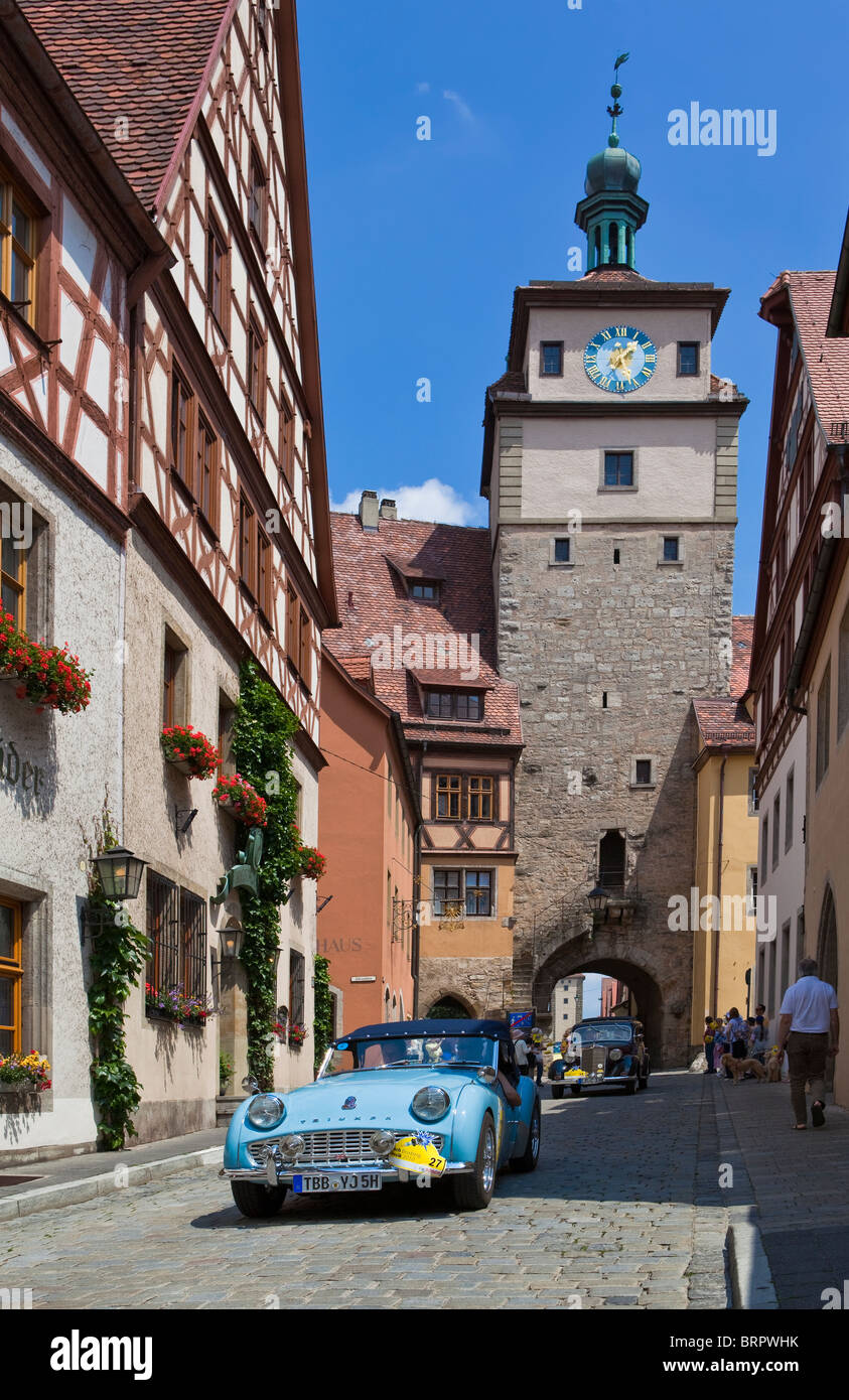 Vintage car rally entering the medieval town Rothenburg ob der Tauber, Bavaria, Germany Stock Photo