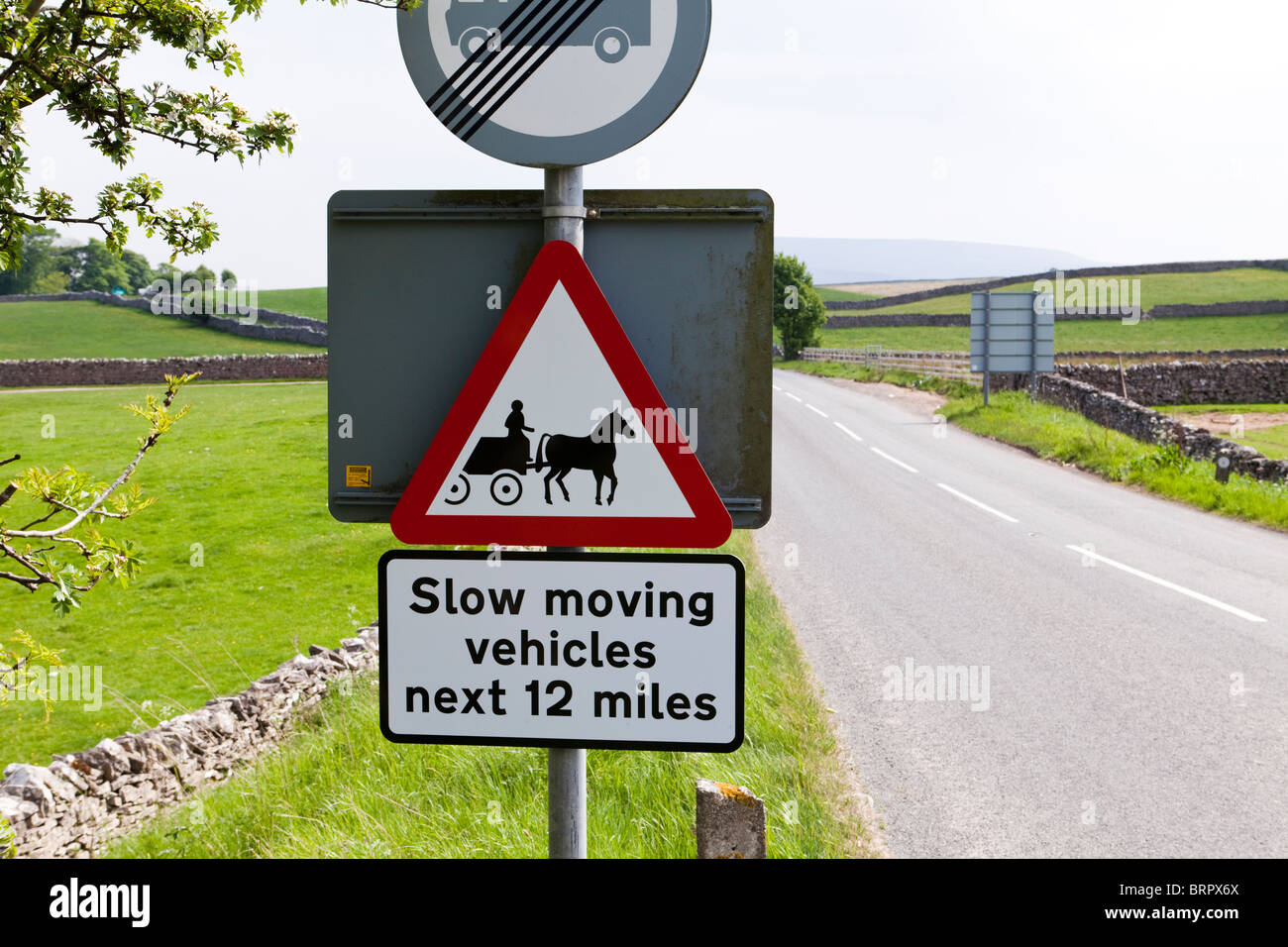 Sign on the A683 NE of Sedbergh, Cumbria warning of slow moving horse drawn vehicles travelling to the Appleby Horse Fair Stock Photo