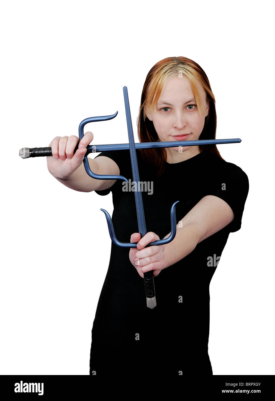 attractive female mma student with sai weapons ready to fight Stock Photo