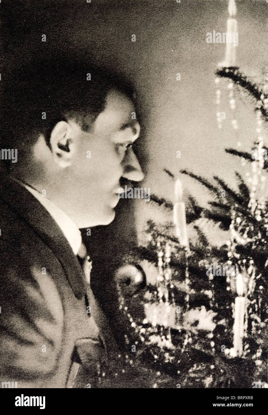 German Nazi picture showing a 'German Christmas'. Shows Adolf Hitler looking into a Christmas tree with candles and glitter. Stock Photo