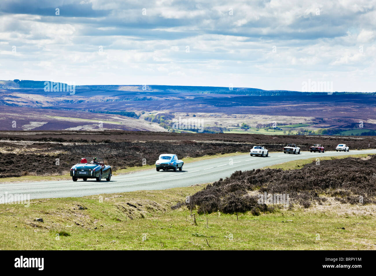 Classic vintage sports cars driving across the North York Moors, England, UK - out for a drive in summer Stock Photo