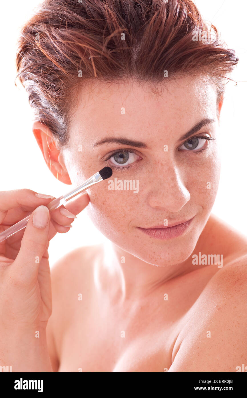 woman applying eyeshadow Stock Photo