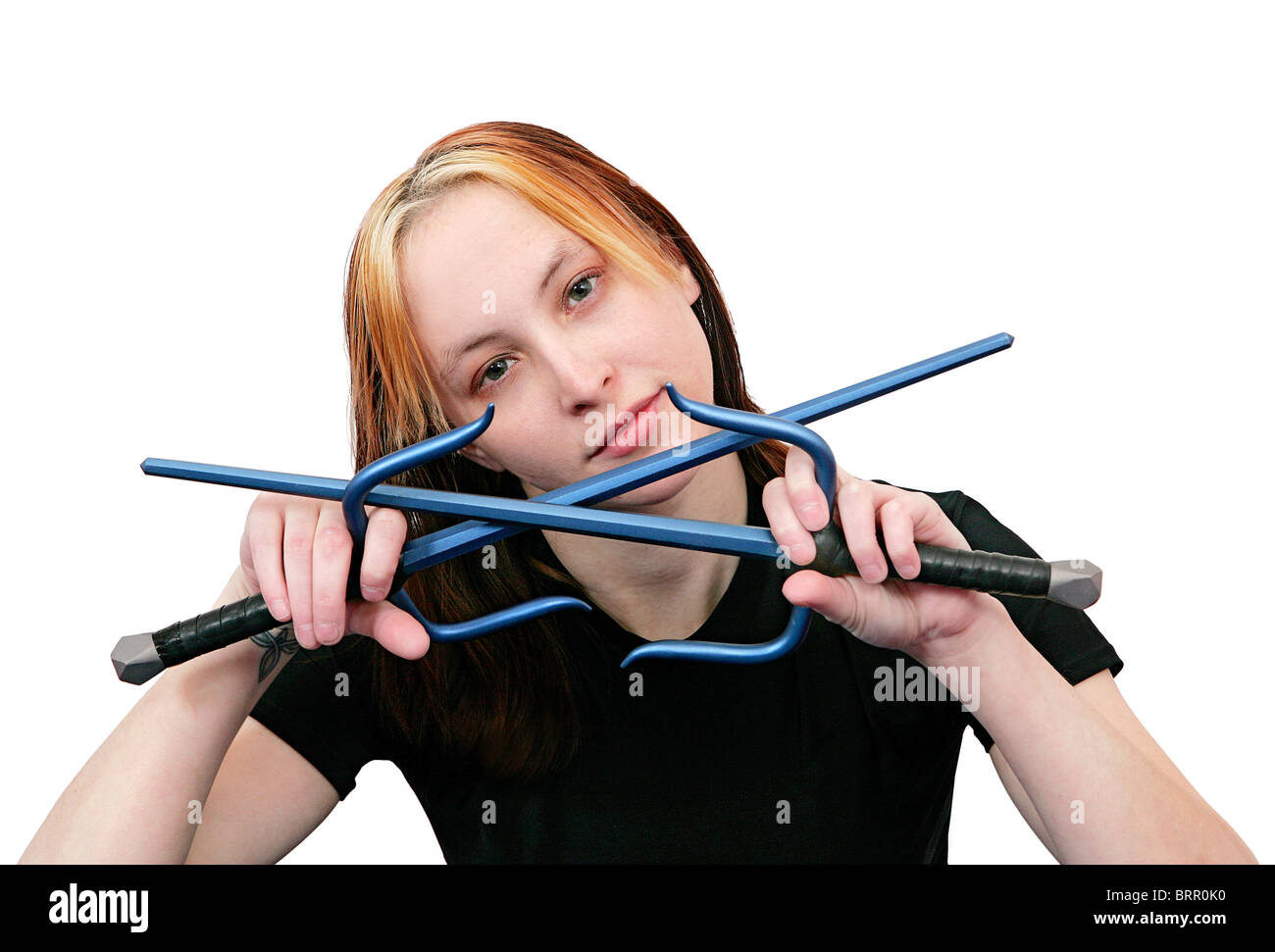 beautiful MMA young woman ready with crossed blue sai weapons over white Stock Photo