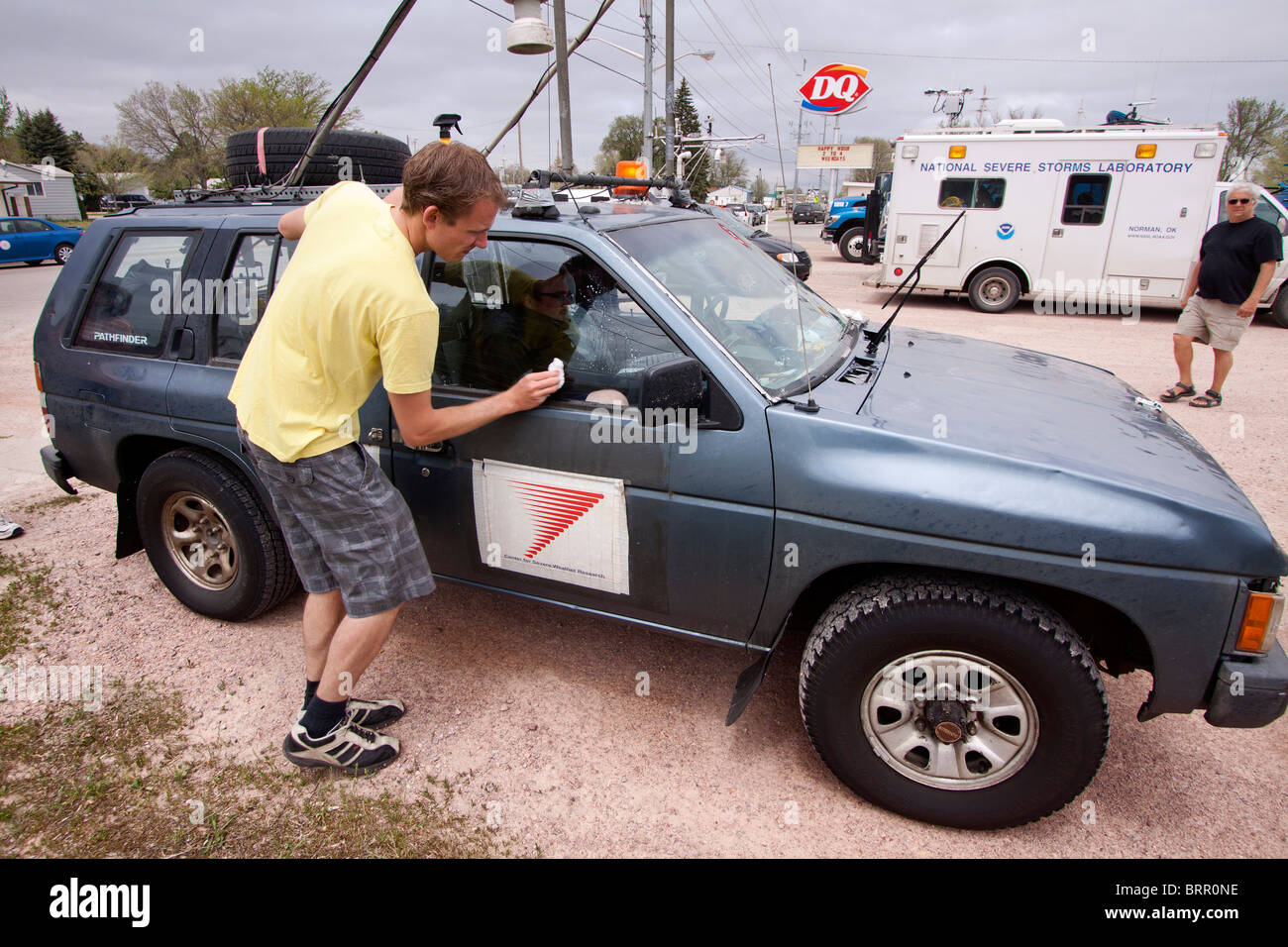 Storm chaser Rutger Boonstra cleans his vehicle's window in rural Nebraska, May 29, 2010. Stock Photo