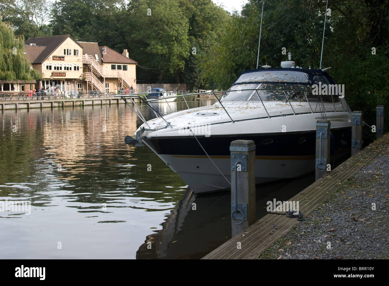 moored large leisure boat river bank trees water Stock Photo - Alamy