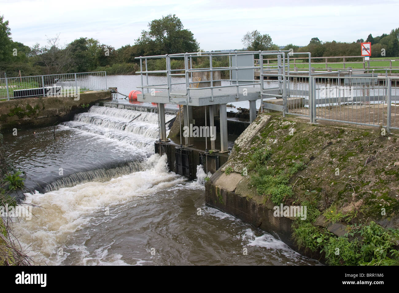 fast flowing weir river water flood control levels Stock Photo