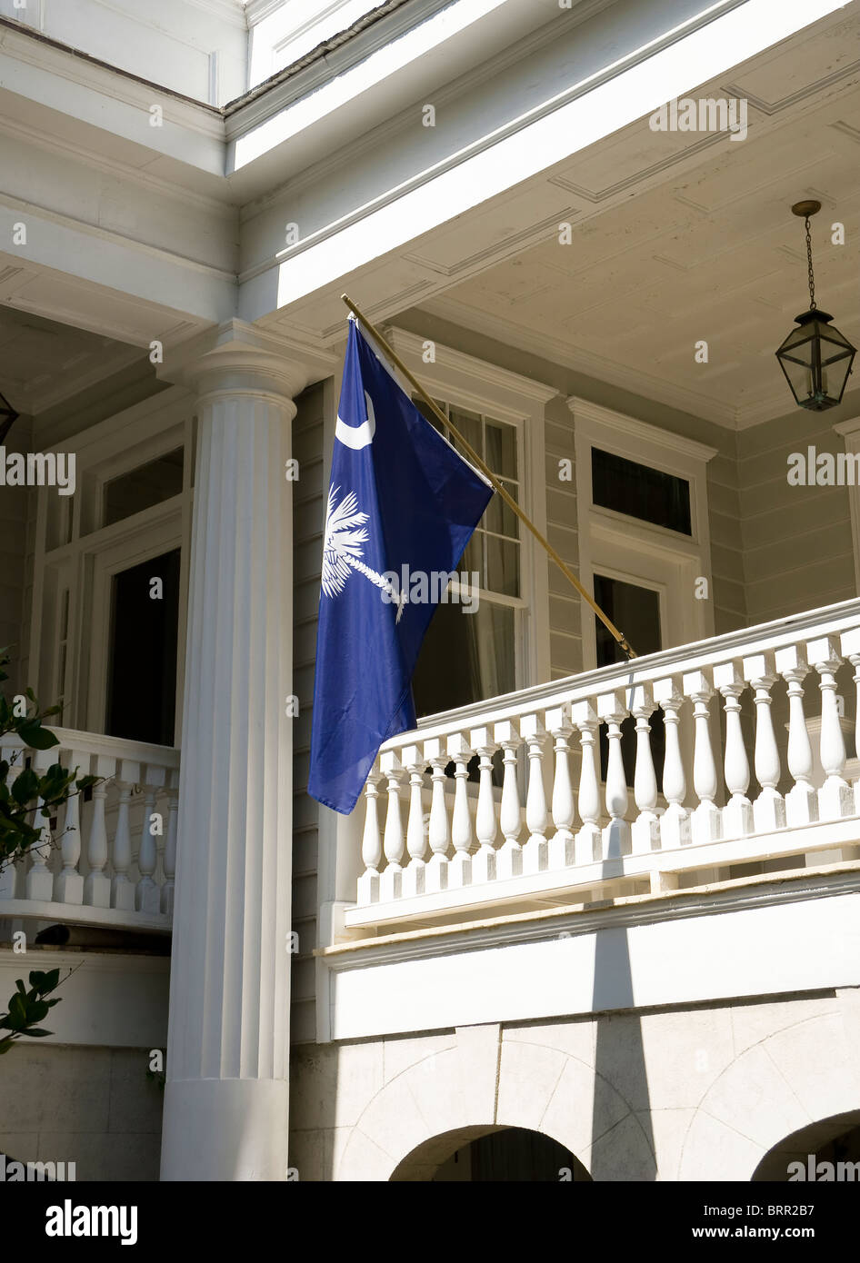 An official  South Carolina State Flag is prominently displayed on a porch in Charleston, SC, USA Stock Photo