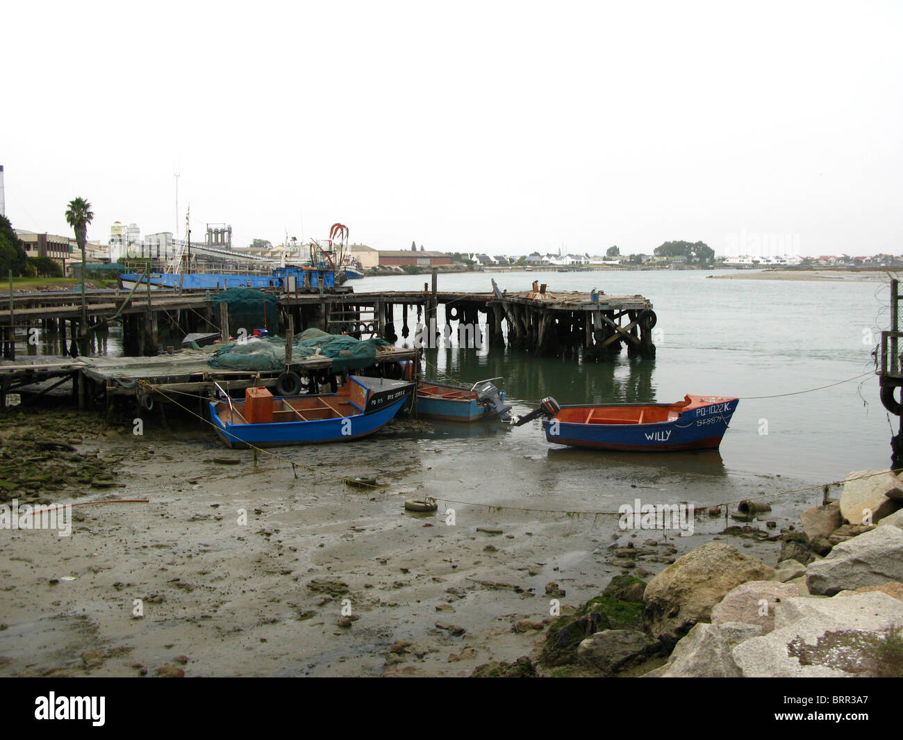 Low tide in the harbour area with fishing boats Stock Photo - Alamy