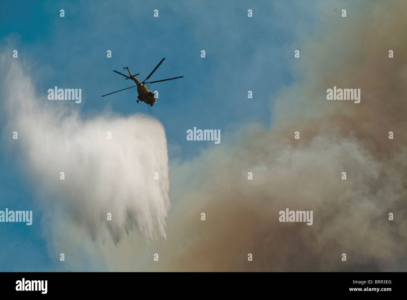Helicopters fighting a mountain fire using waterbombs Stock Photo Alamy