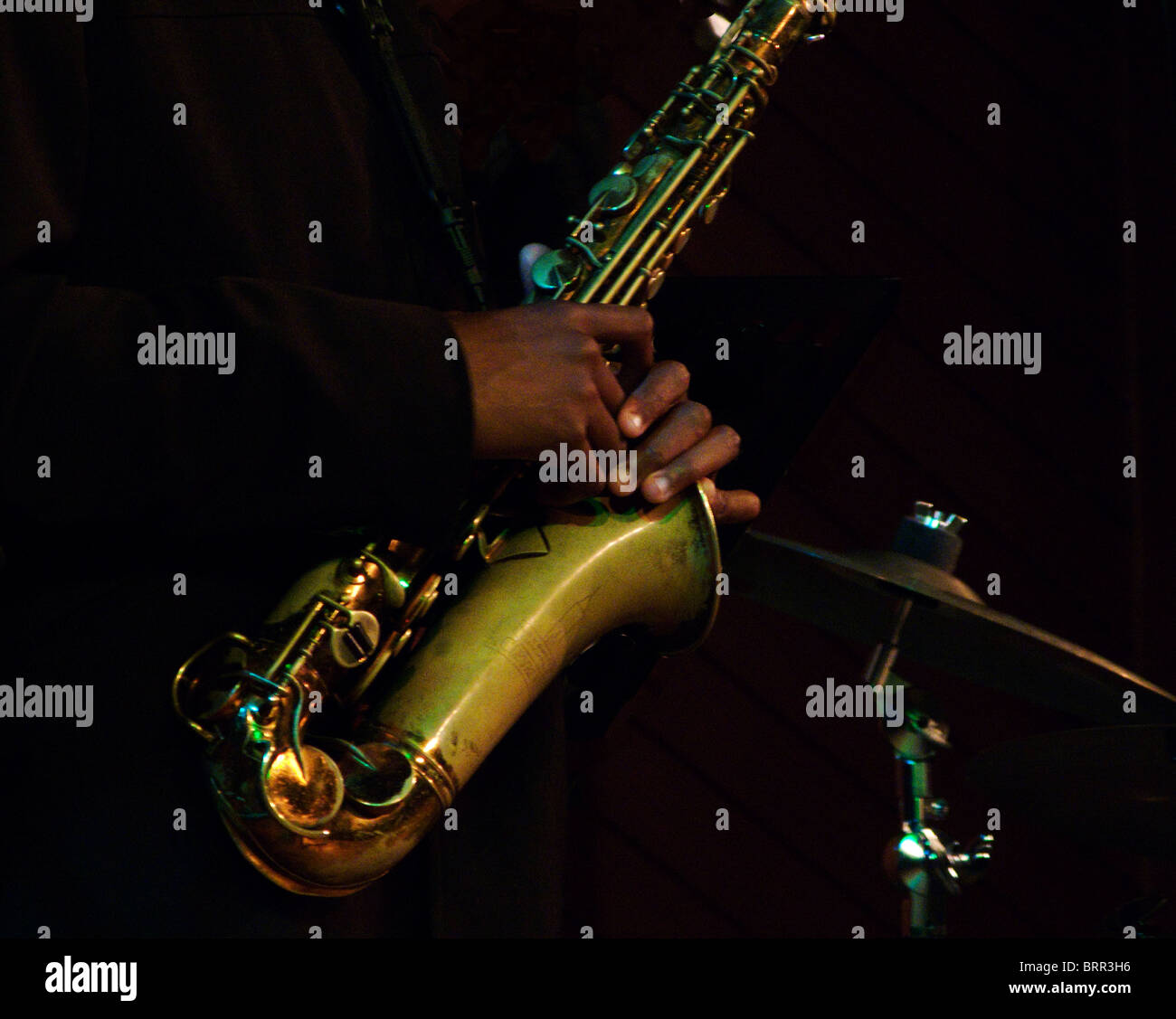 Saxophone being held by a musician Stock Photo