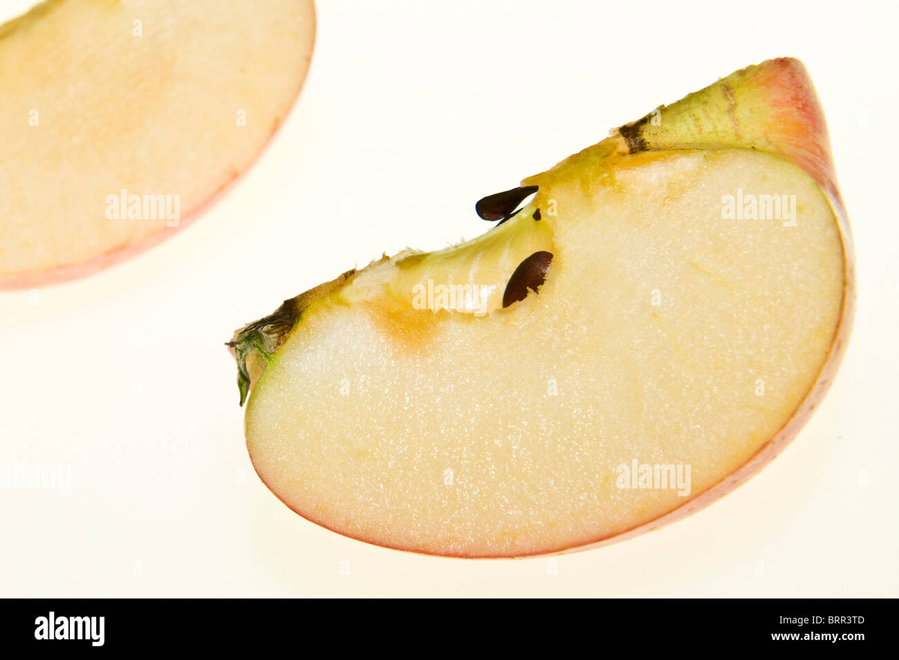 Close-up studio shot of an apple sliced into quarters Stock Photo
