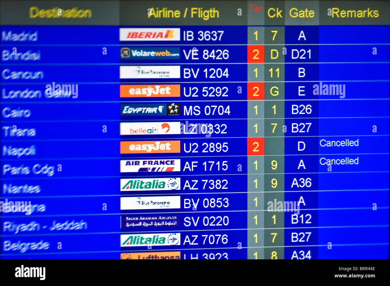 Airport information board showing arrivals and departures of flights Stock Photo