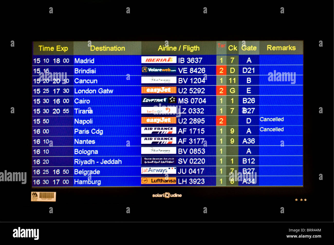 Airport information board showing arrivals and departures of flights Stock Photo