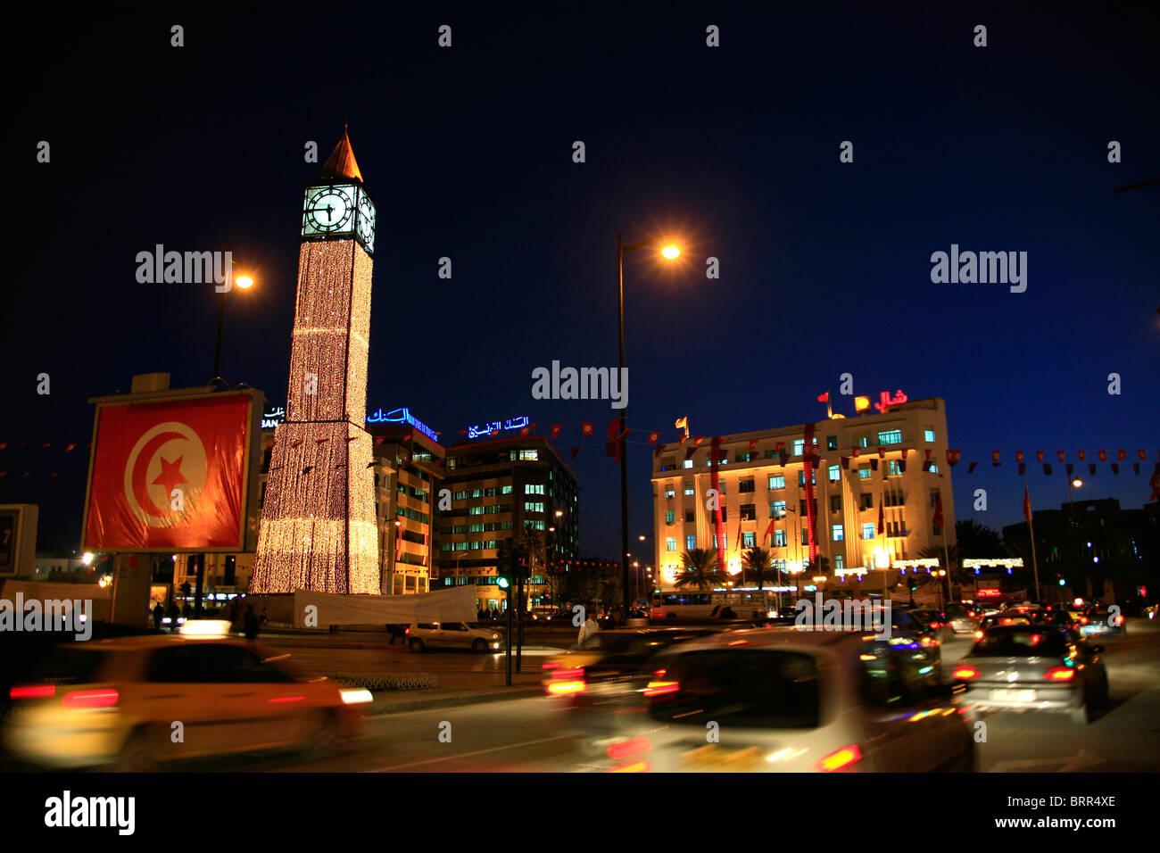 Night time city scene with clock tower and traffic on the main street of Tunis, Avenue Habib Bourguiba Stock Photo