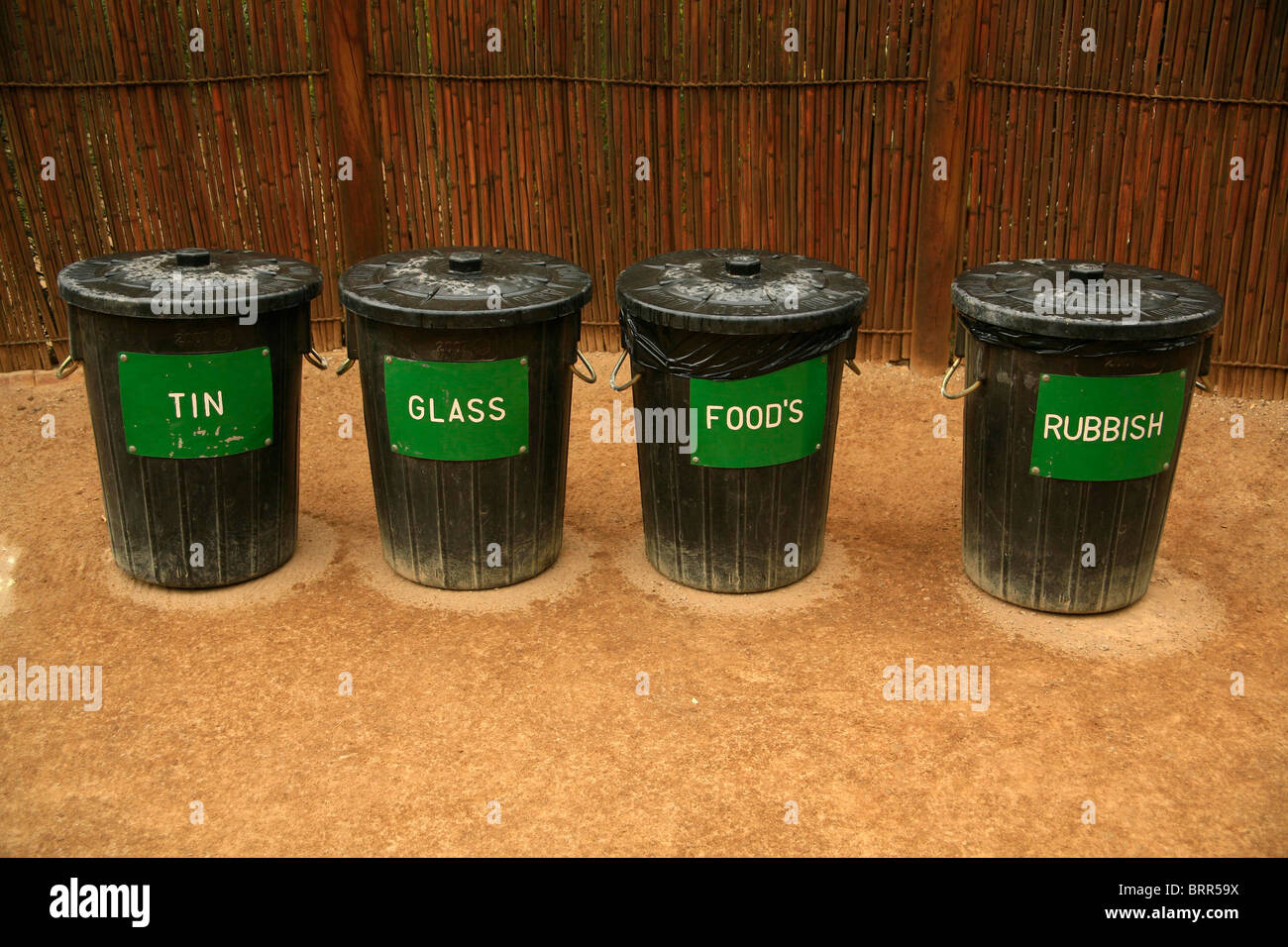 A row of recycling bins for tins, glass, food waste and unclassified rubbish Stock Photo