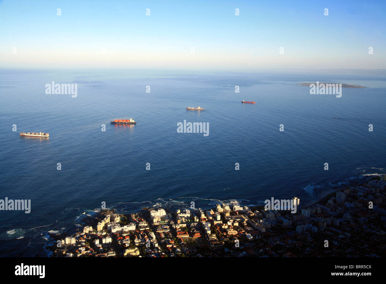 Boats anchored in Table Bay with Robben Island in the distance Stock Photo