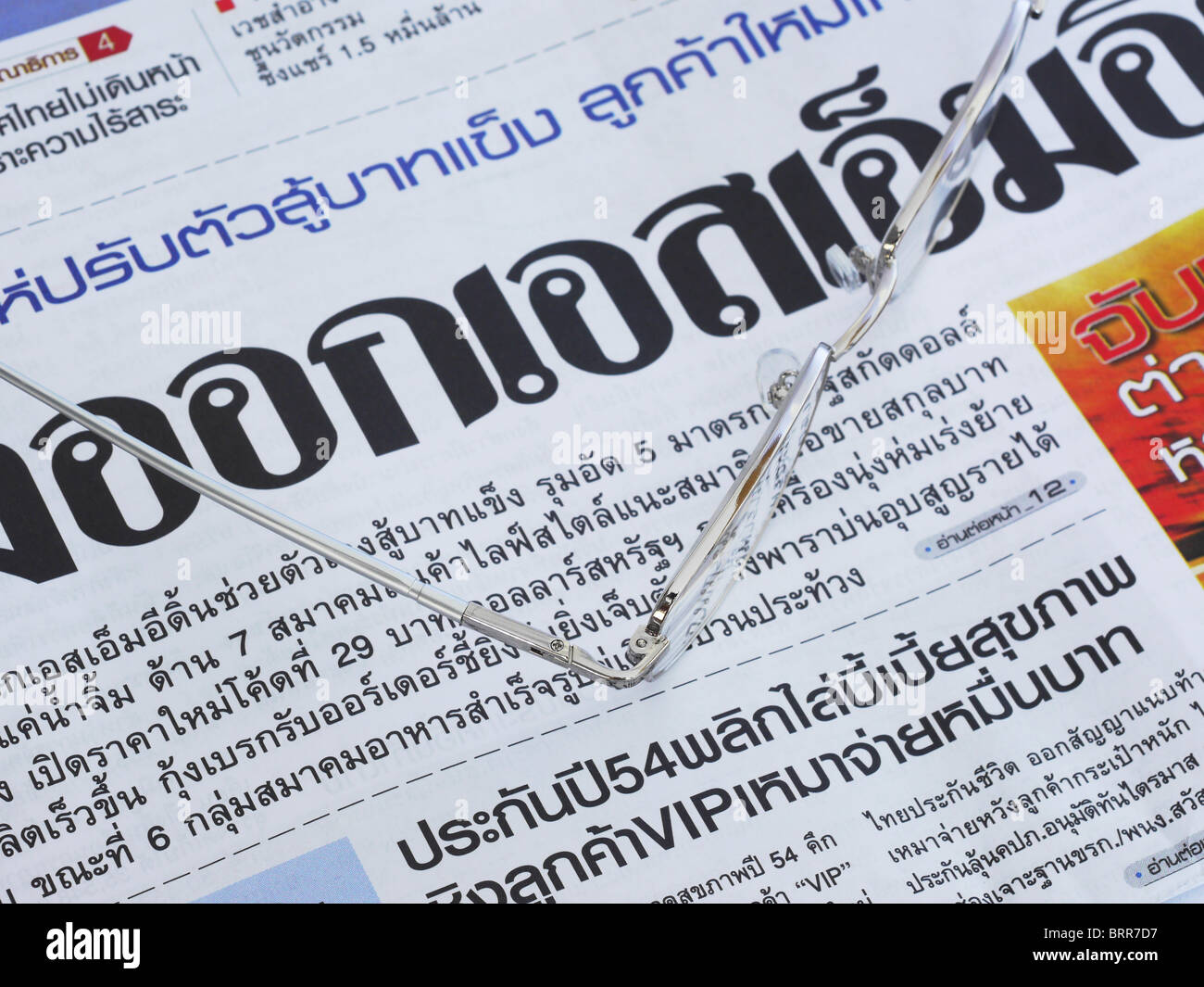 Close-up of Thai language newspaper and a pair of glasses Stock Photo -  Alamy