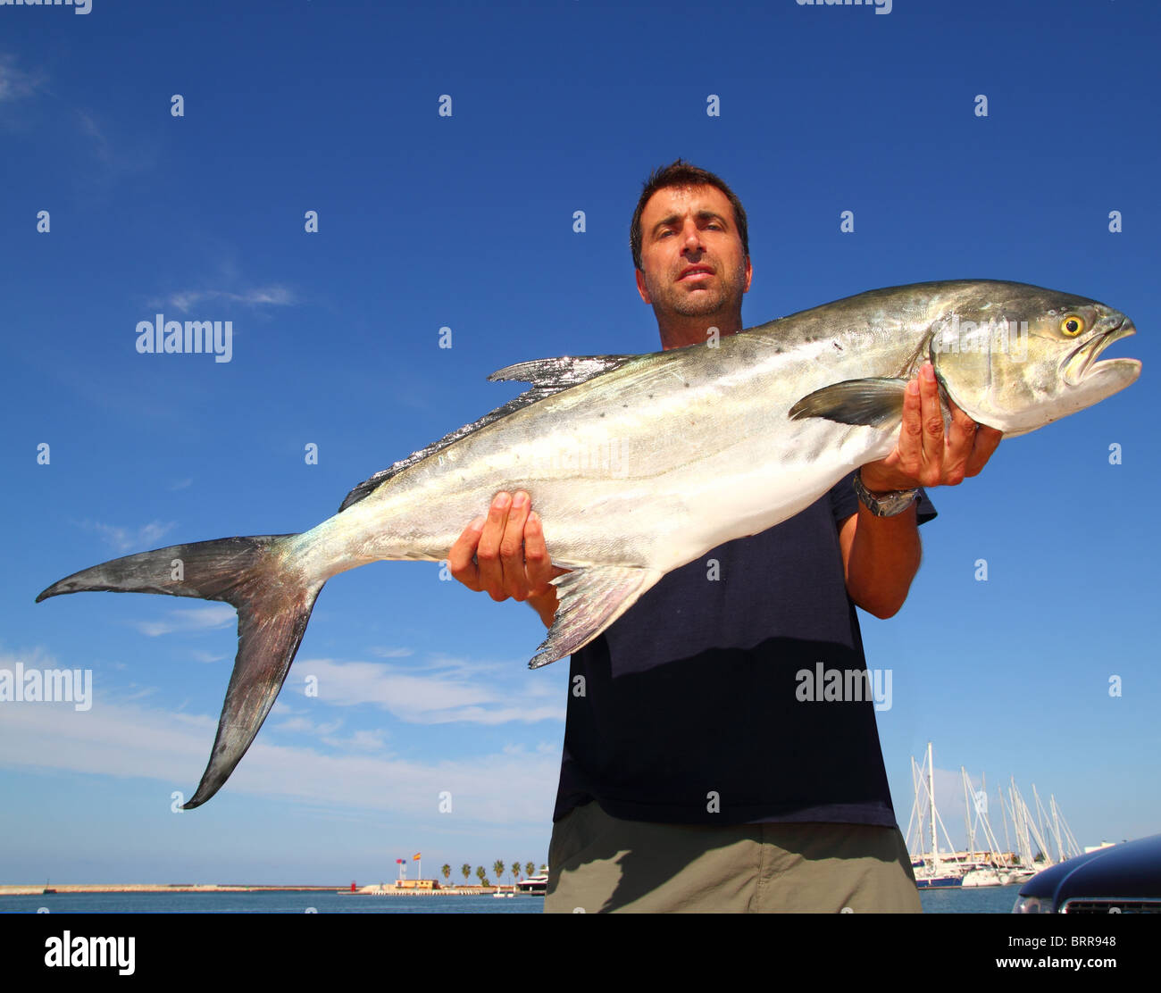 Fisherman holding catch Garrick Lichia Amia Leerfish Leervis fishJack Stock Photo