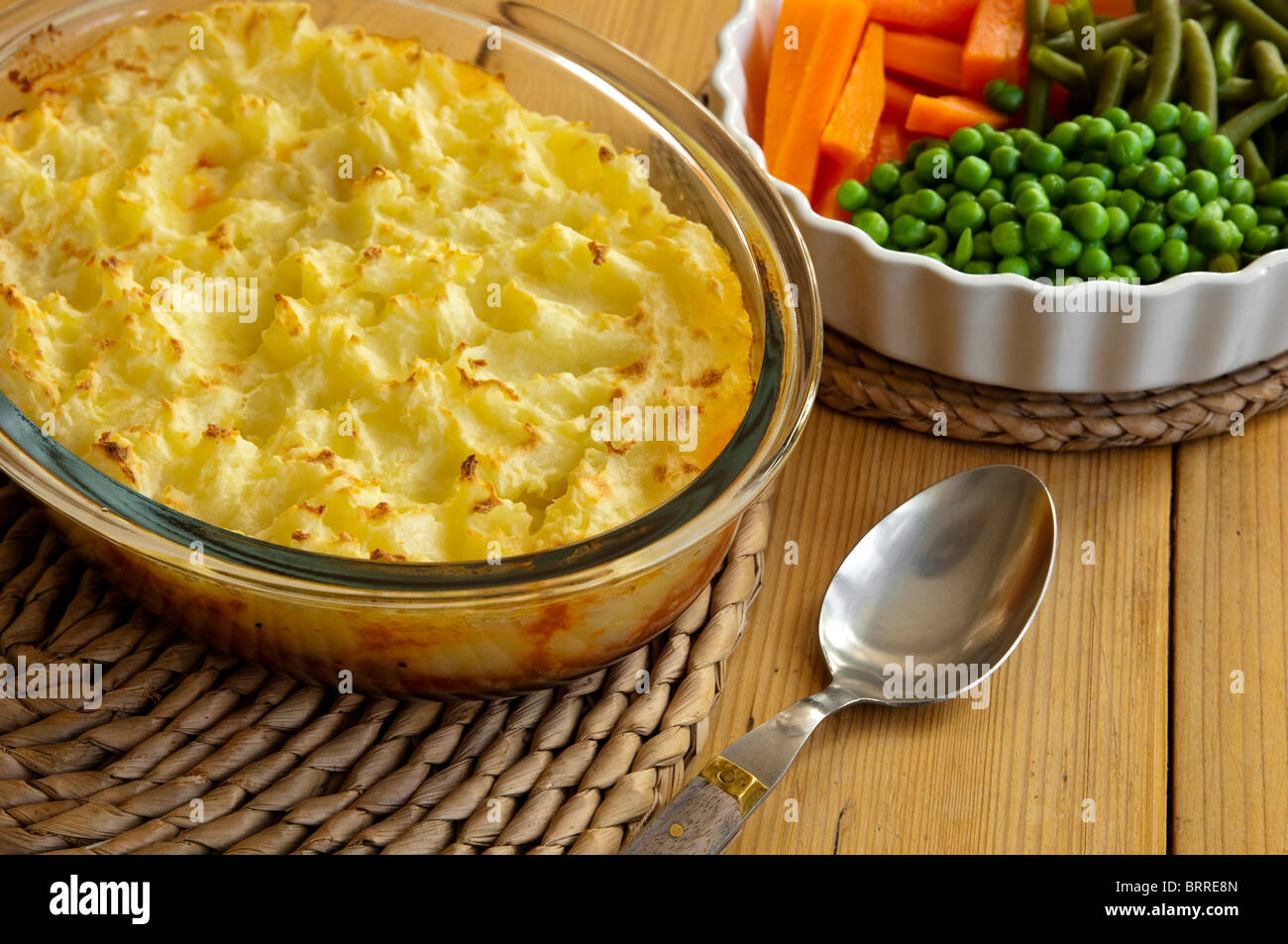 Shepherds Pie, with vegetables - carrots, french beans and peas - healthy home cooking ready to be served. Stock Photo