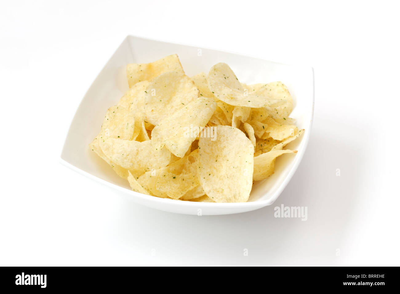 Crisps in a white ceramic bowl Stock Photo