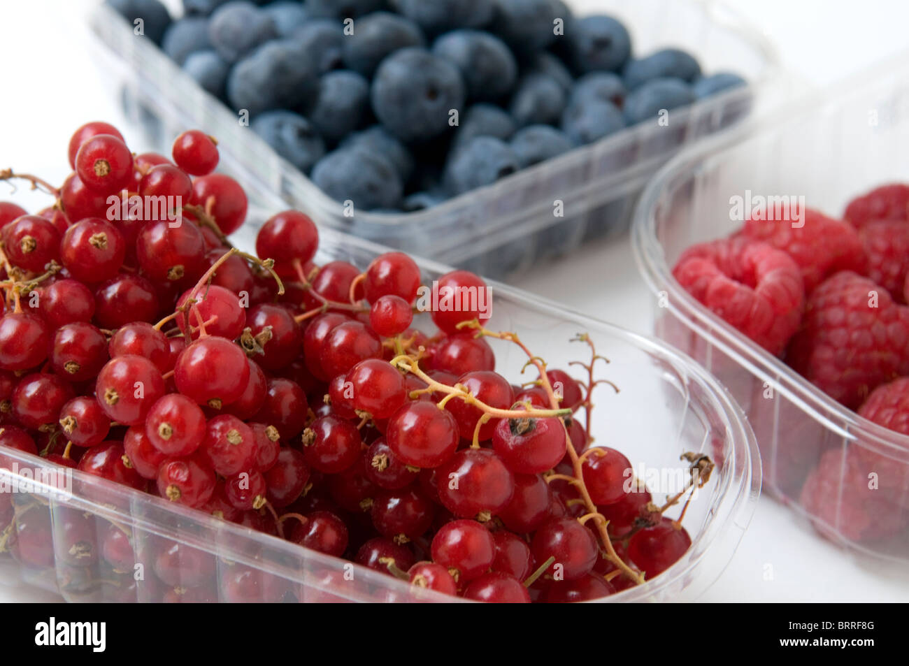 three baskets of blueberries,blackberries and raspberries Stock Photo