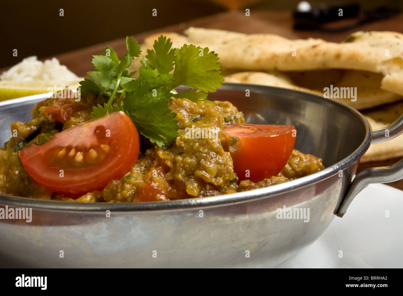 Indian Curry meal of spicy chicken, rice and naan bread. Stock Photo