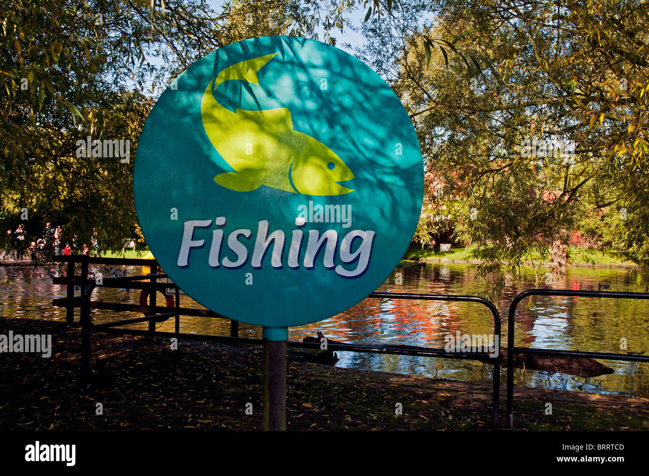 A large colourful sign by the lake side indicates that fishing is permissible at Primrose Valley Holiday Park, Filey Stock Photo