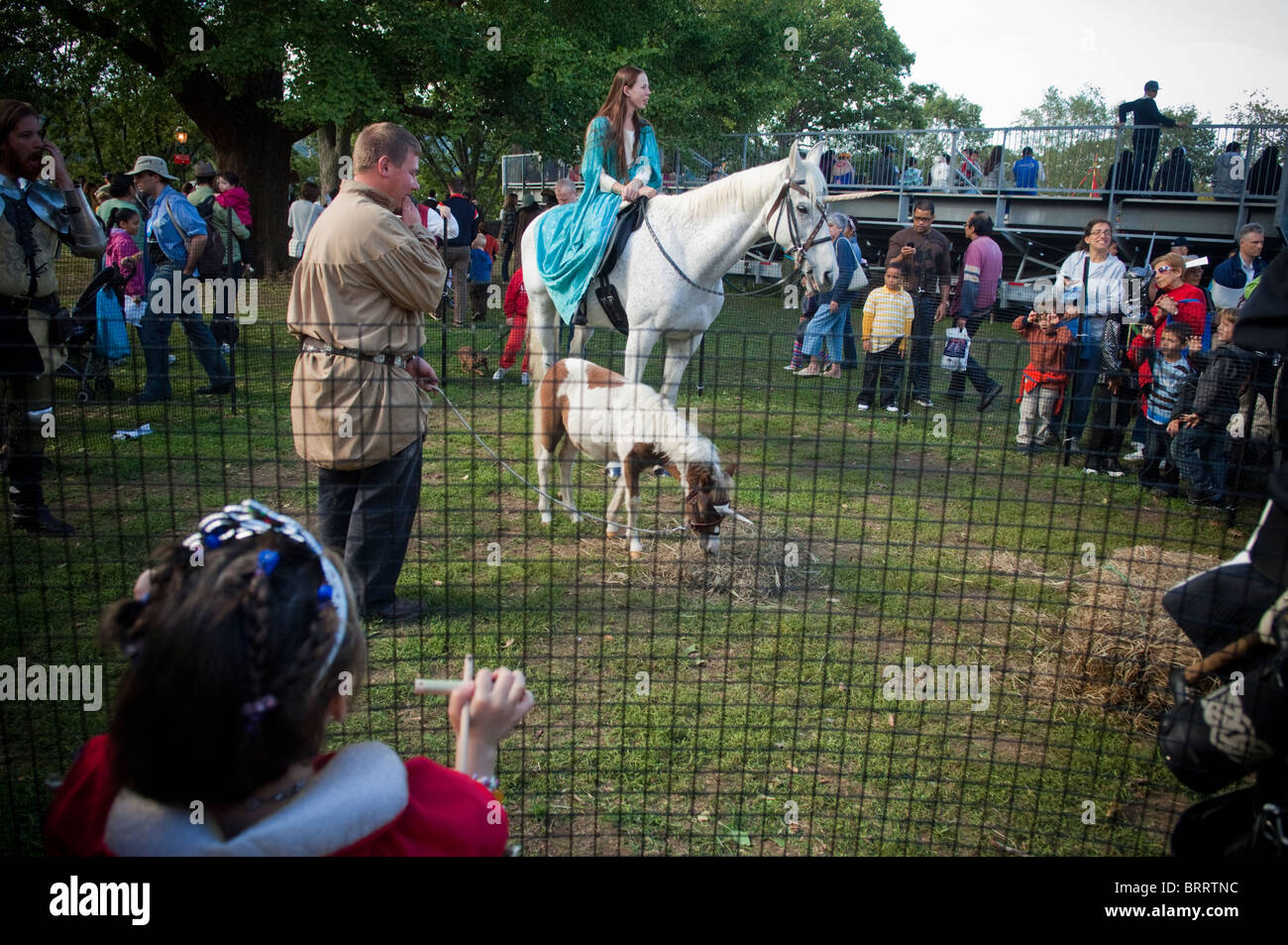 A horse and pony in costume as unicorns attend the 26th annual Medieval Festival in Fort Tryon Park in New York Stock Photo