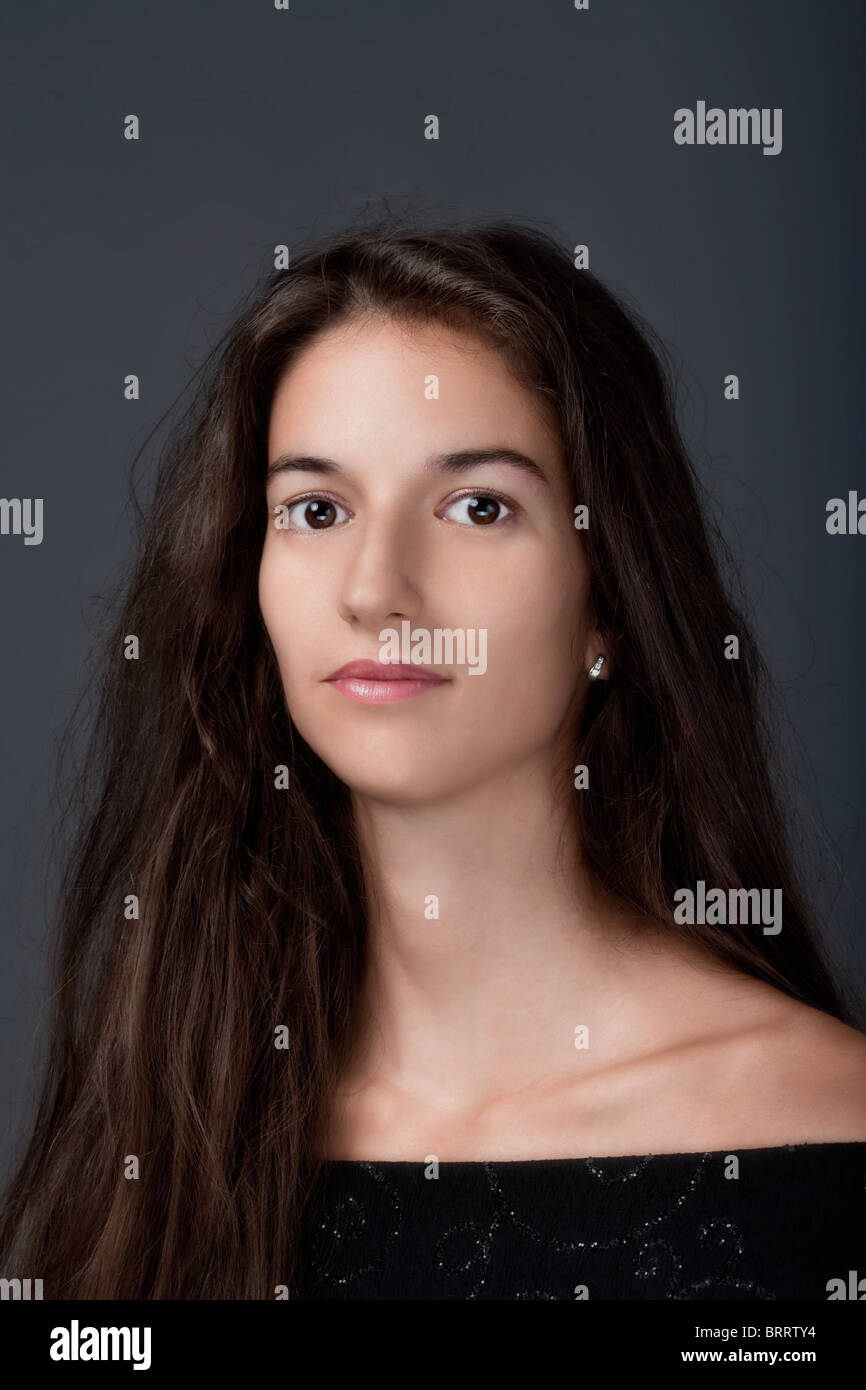 portrait of a woman with brown hair and brown eyes - isolated on gray ...