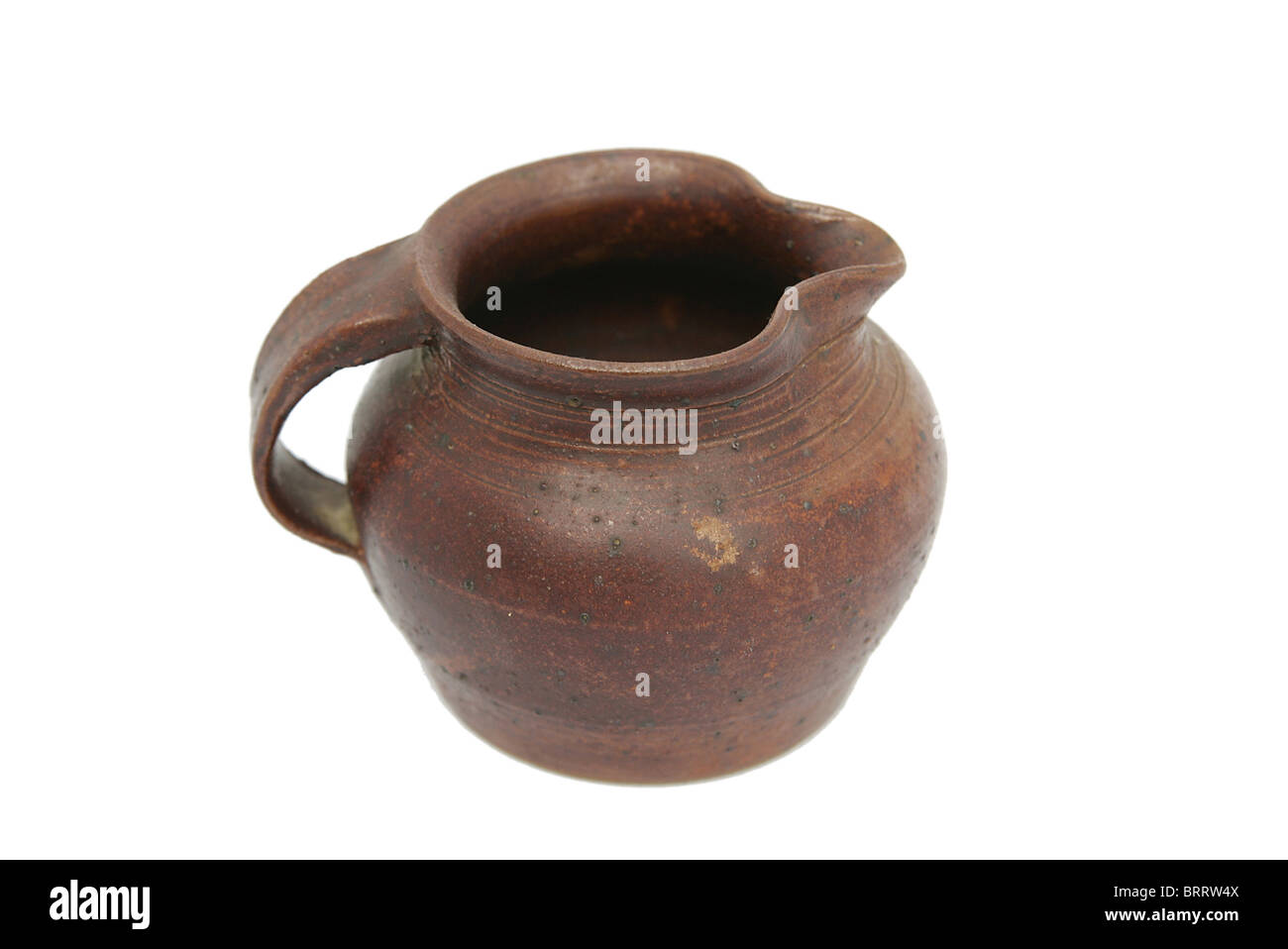 an old antique jug over a white background Stock Photo - Alamy