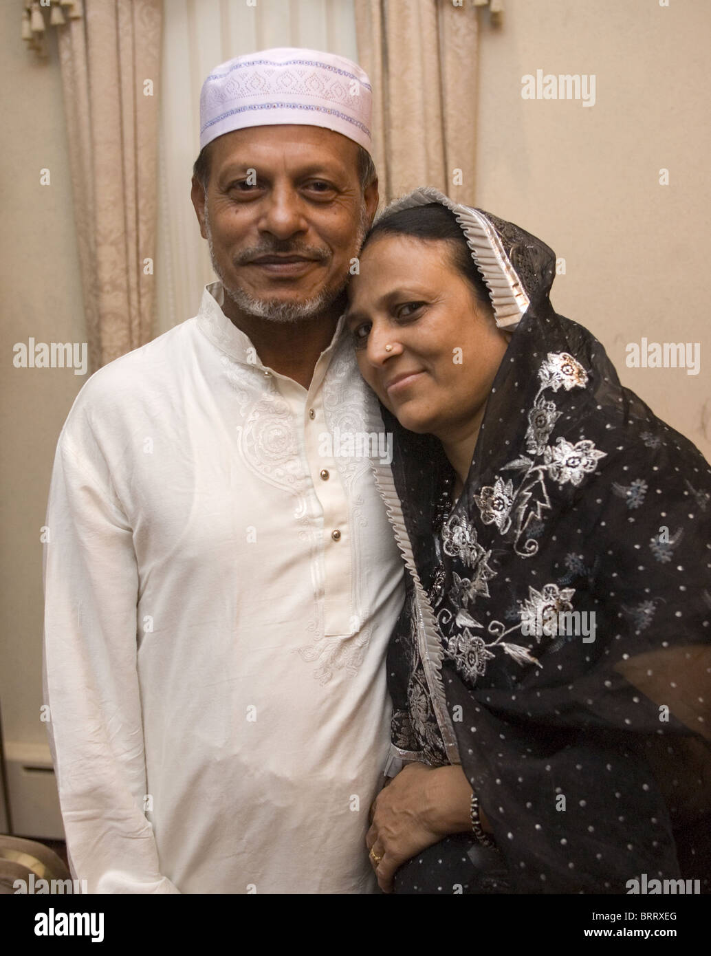 Bangladeshi husband and wife living in Brooklyn, New York in prayer