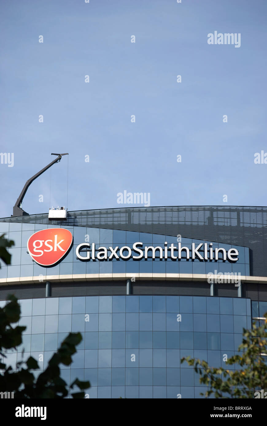 world headquarters of pharmaceutical company gsk, or glaxo smith kline, showing logo and crane for window cleaning cradle Stock Photo