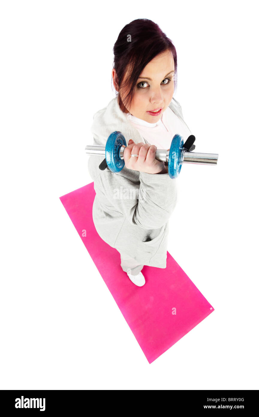Young, fat woman trainingwith weights on a mat Stock Photo