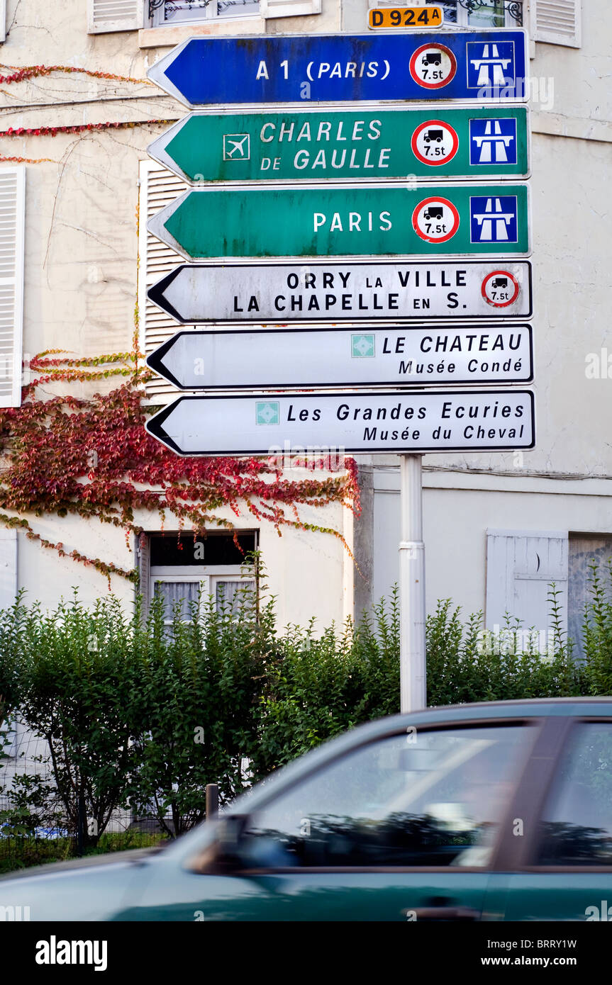 Traffic signs on the main road through the town of Chantilly in France Stock Photo