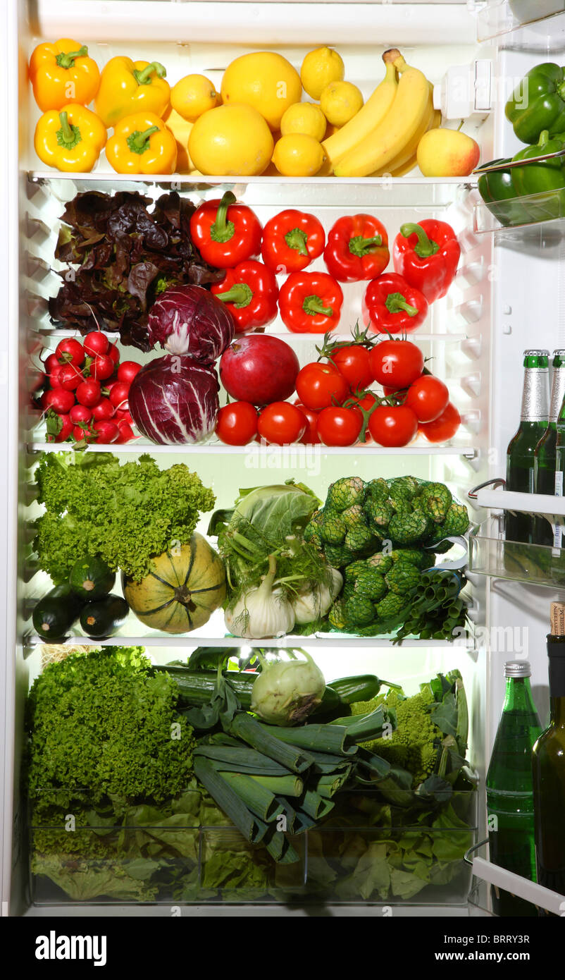 Refrigerator filled with many different vegetables, fruits, salads